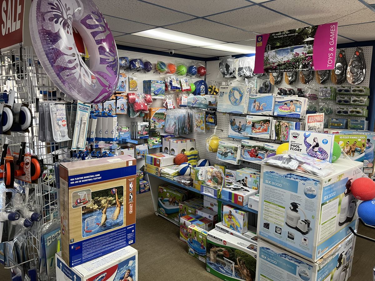 Aisles of pool toys, floats, and supplies at Tak-It-EZ